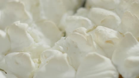 top view of meringue cracking in slow motion as knife gently cuts through to soft lemon curd below. close up of indulgent sweet homemade dessert food. high in sugar and flavour