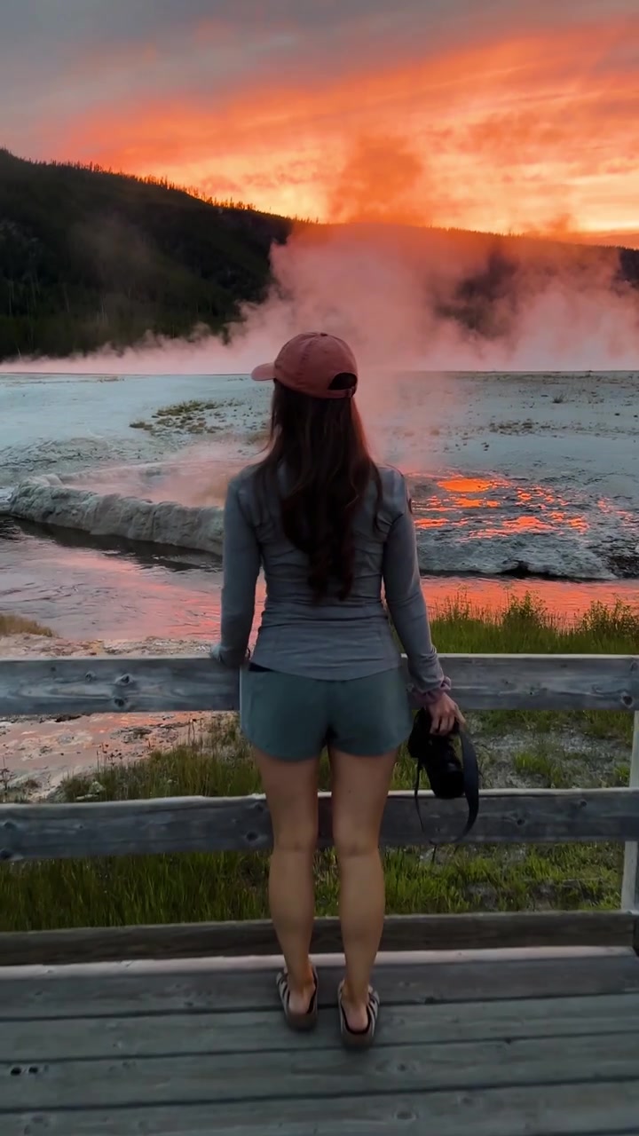 Vertical View, Back of Woman With Photo Camera Walking at Lookout Point in Yellowstone National Park USA at Sunset