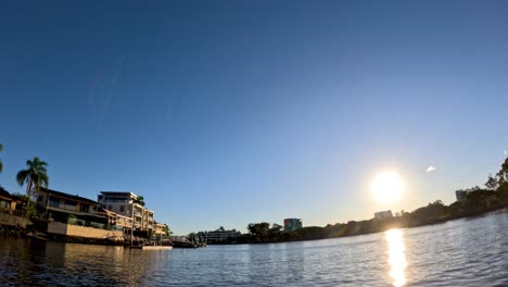 sun setting over waterfront buildings and pier