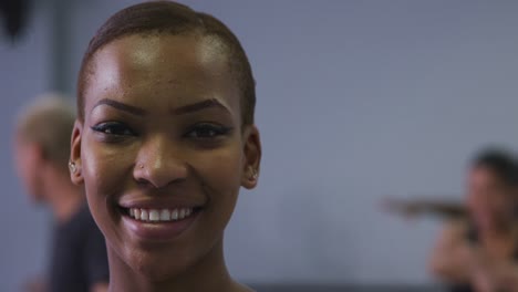 Portrait-of-a-mixed-race-modern-female-dancer-looking-at-the-camera