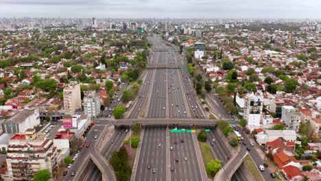 4K-high-quality-scenic-footage-of-a-drone-flying-over-thousands-of-vehicles-driving-along-Pan-American-motorway-in-Buenos-Aires-city,-Argentina