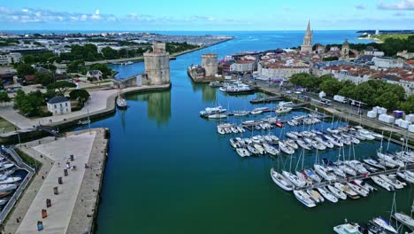 the old port with saint nicolas and lantern tower in background, la rochelle, france