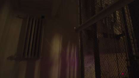 dark stairwell interior with metal grate and radiator