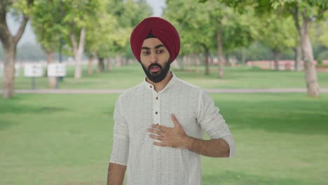 sick sikh indian man having an asthma attack in park