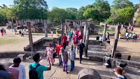 visitors enjoying the ancient hatadage shrine in the historic city of polonnaruwa, sri lanka, showcasing cultural and architectural heritage amidst lush greenery.