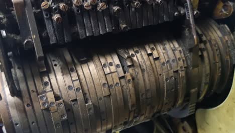close-up of a dusty cam drum from a 1950s sock knitting machine, once part of yugoslavia’s textile industry. vintage metal parts and worn industrial details evoke a bygone era