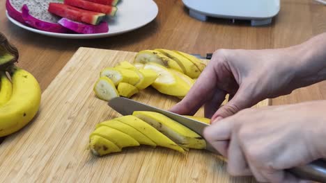 slicing bananas on a wooden cutting board