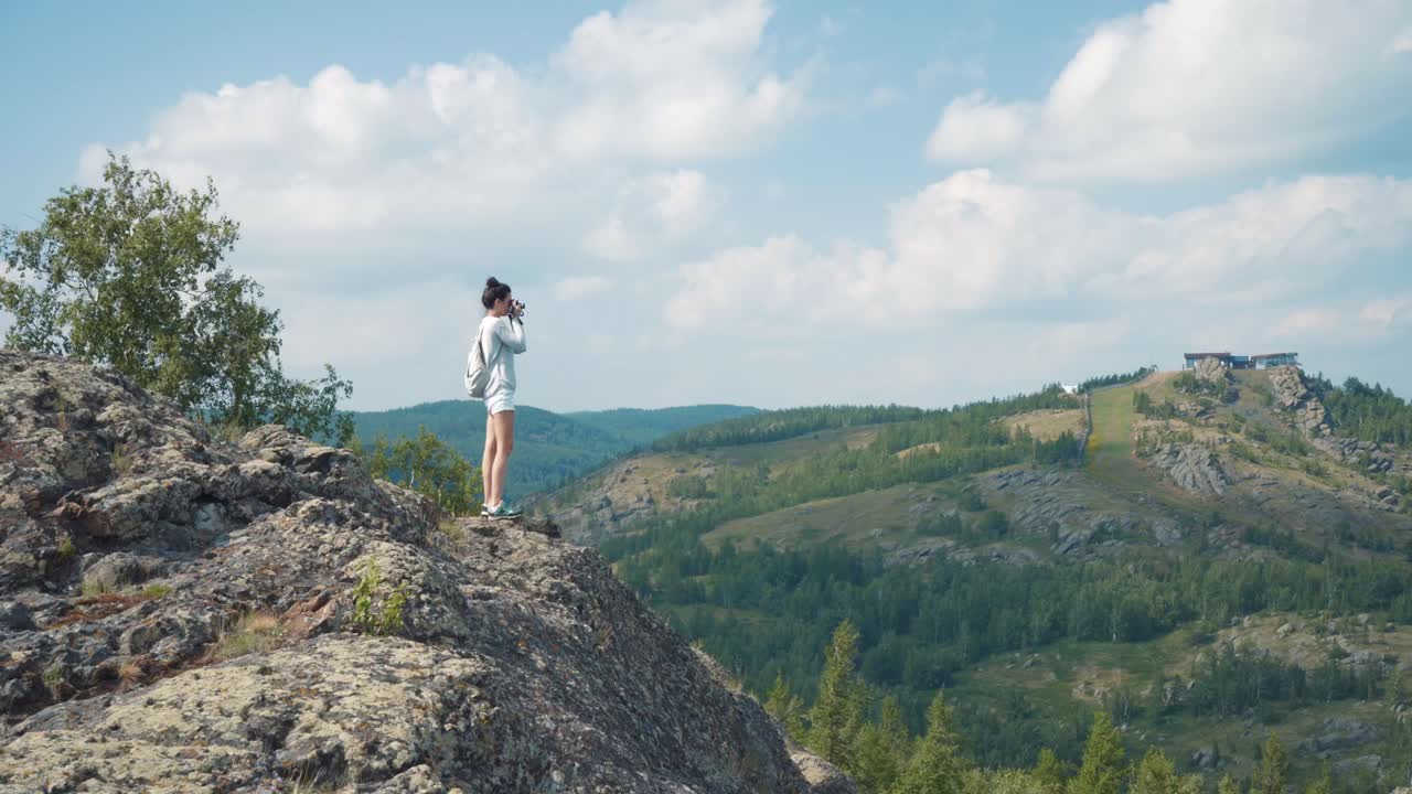 Woman Hiking and Taking Pictures of a Mountain View