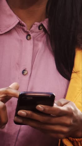 mid section young woman texting and enjoying walk by canal