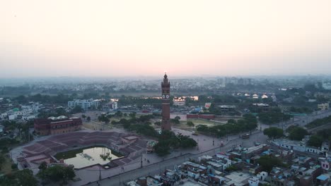 aerial view of the clock tower in lucknow, with the first light of day illuminating the city’s skyline.