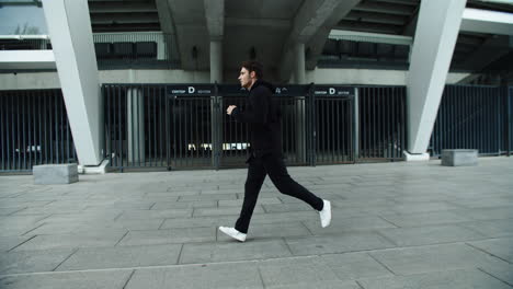 Sportsman-running-on-urban-street-in-slow-motion.-Runner-male-jogging-outdoor