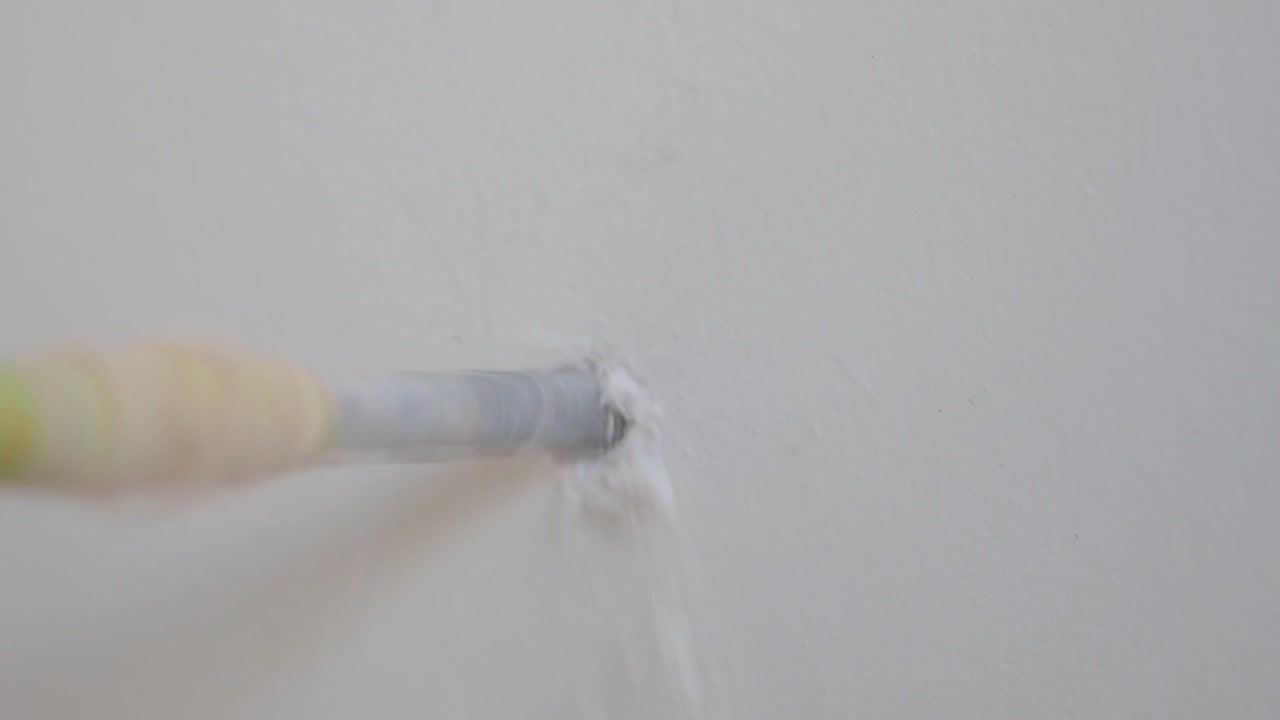 Drilling a hole in a wall