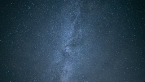 thick clouds in night sky reveal bright stars of milky way nebula band