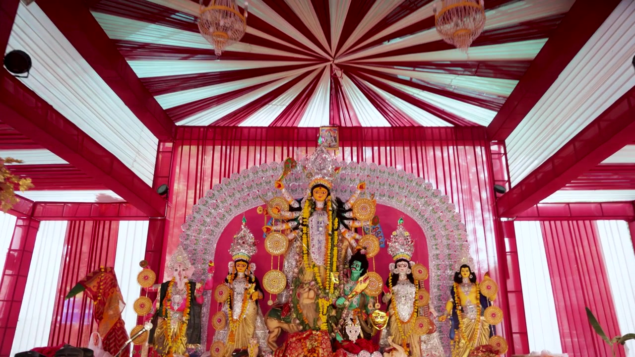Goddess Durga Statue at Durga Puja Pandal Interior With Floral Decorations and Chandeliers