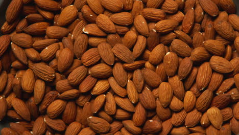 overhead full frame shot of almond nuts revolving on turntable shot in slow motion