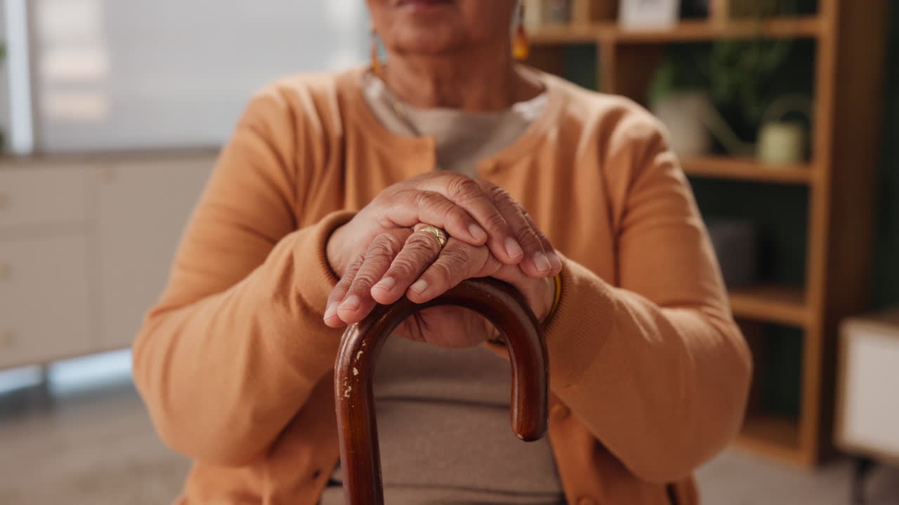 Close up of an elderly woman holding a walking cane