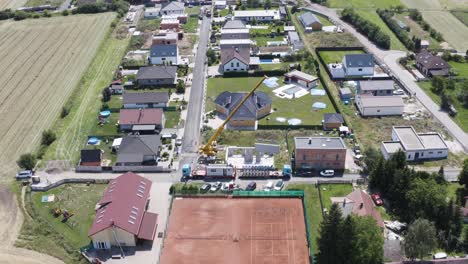 modular house construction site with mobile crane in town in czechia