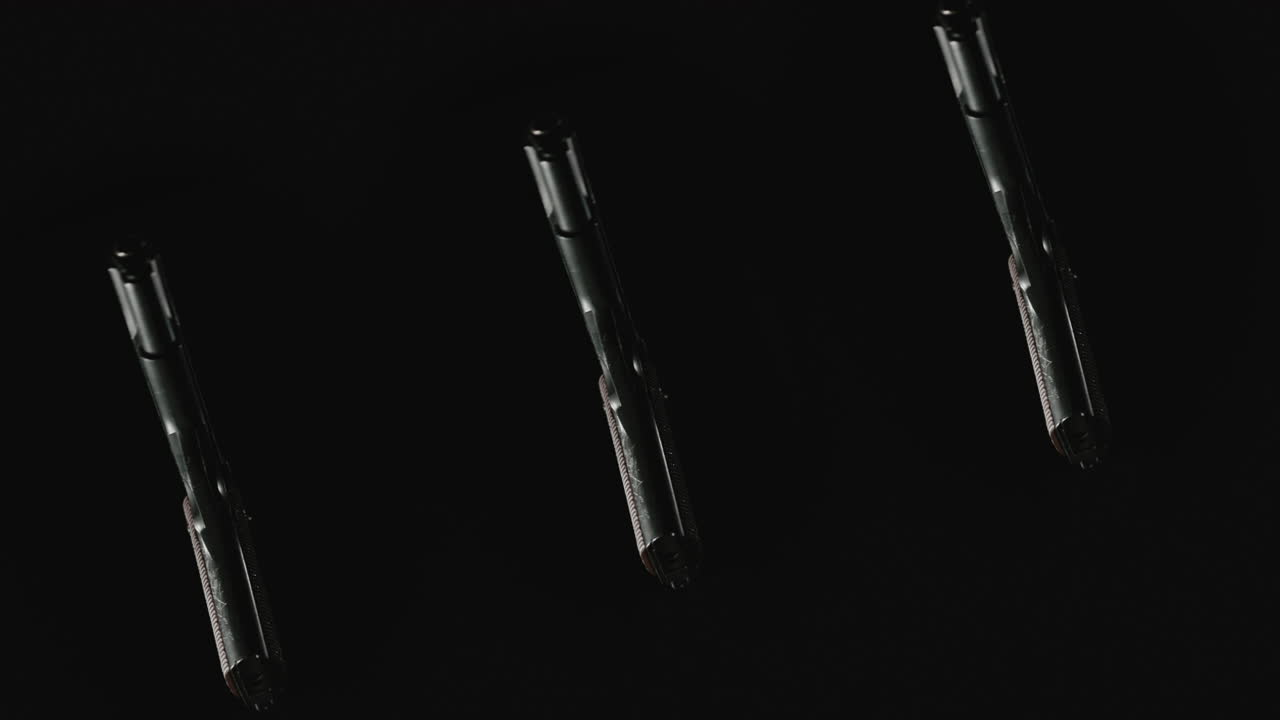 Three pistols on the dark background rotate in slowmotion