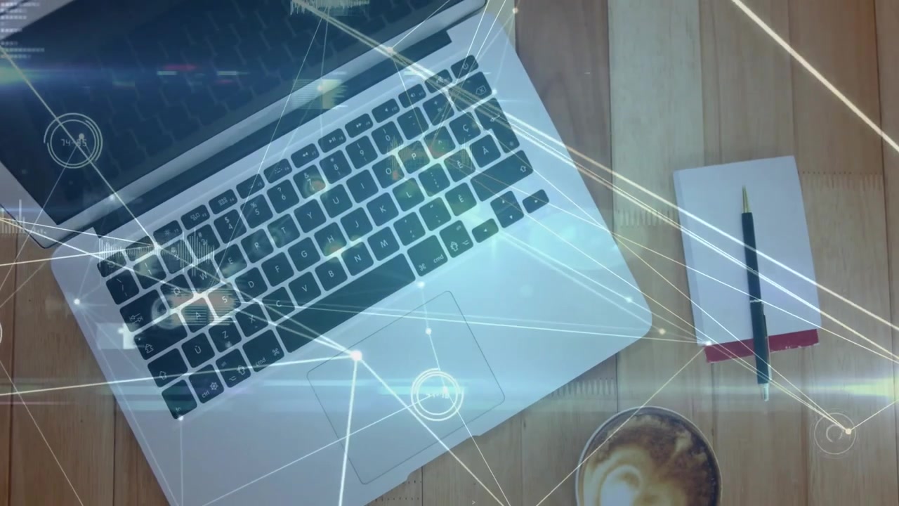 HUD fading on silver laptop and notebook pen starting glowing mesh forming workspace by coffee mug