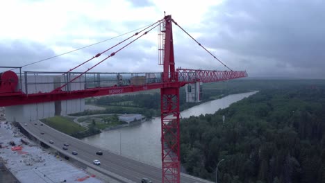 crane by busy highway bridge construction zone flyover