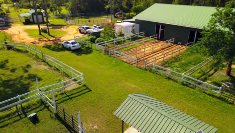 a drone shot of the out door stalls of a horse ranch