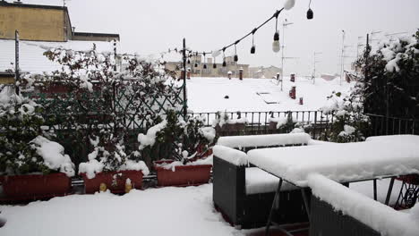 heavy snow falling over open balconies of an apartment building