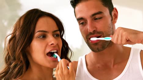 couple washing their teeth with toothbrush