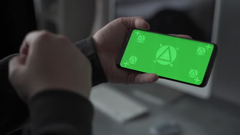 smartphone with horizontal green screen chroma. swiping and scrolling. mockup. close-up.