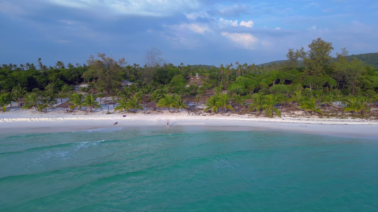 Tourist walking on the white sand beach of Koh Rong island in Cambodia, Asia Fabulous aerial view flight fly push forward drone