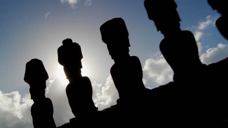 easter island statues are silhouetted against the sky