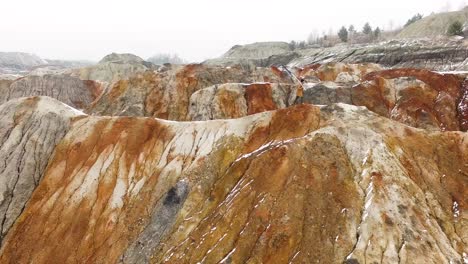 colorful quarry landscape with person holding flag in winter