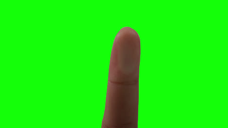 caucasian man pointing on green background