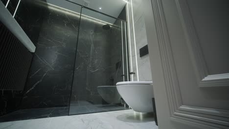 contemporary bathroom with marble accents and vertical lighting