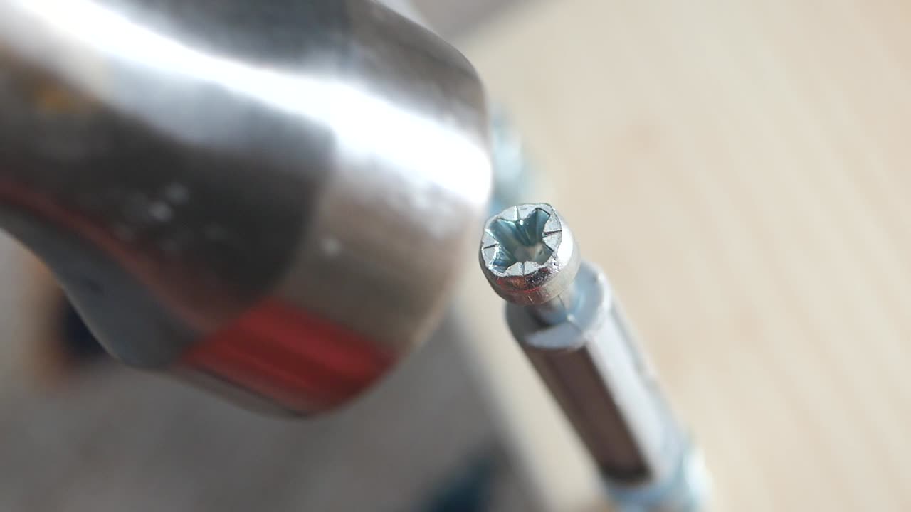 Close-up of a screw and screwdriver