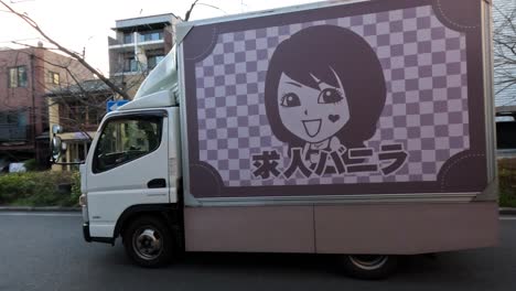 truck with advertisement driving through residential area