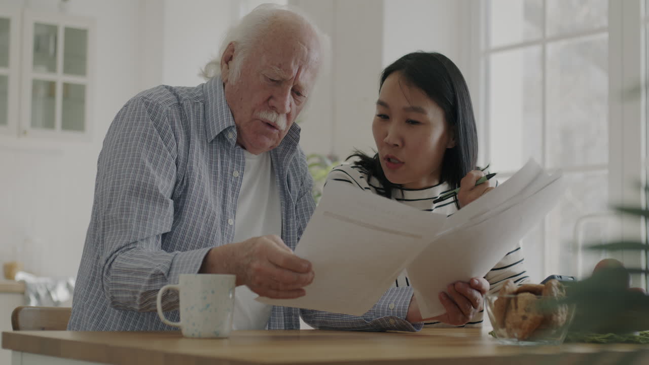 Elderly Man and Woman Reviewing Documents at Home