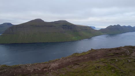 aerial panning right shot of kalsoy island seen from klakkur mountain, faroe islands