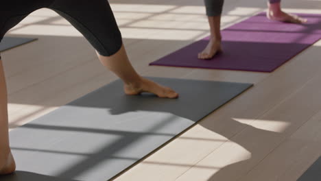 yoga class feet group of women practicing poses enjoying meditation practicing posture standing on exercise mat in fitness studio at sunrise