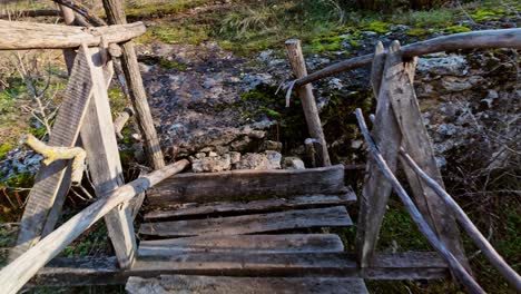 pov slow cautious crossing on aged wooden footbridge on hike trail