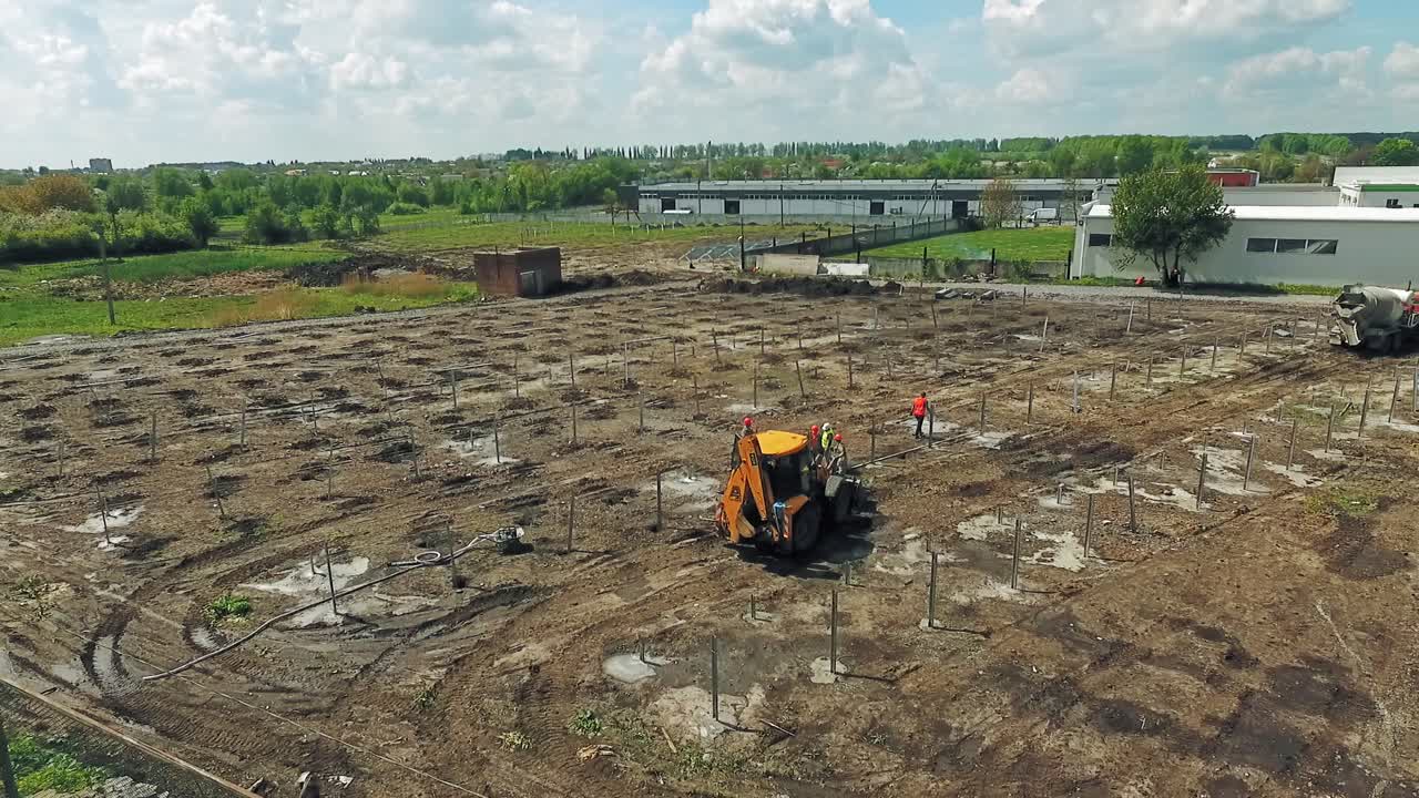 Aerial View Of Construction Site. Workers in safety protective equipment installing at construction site