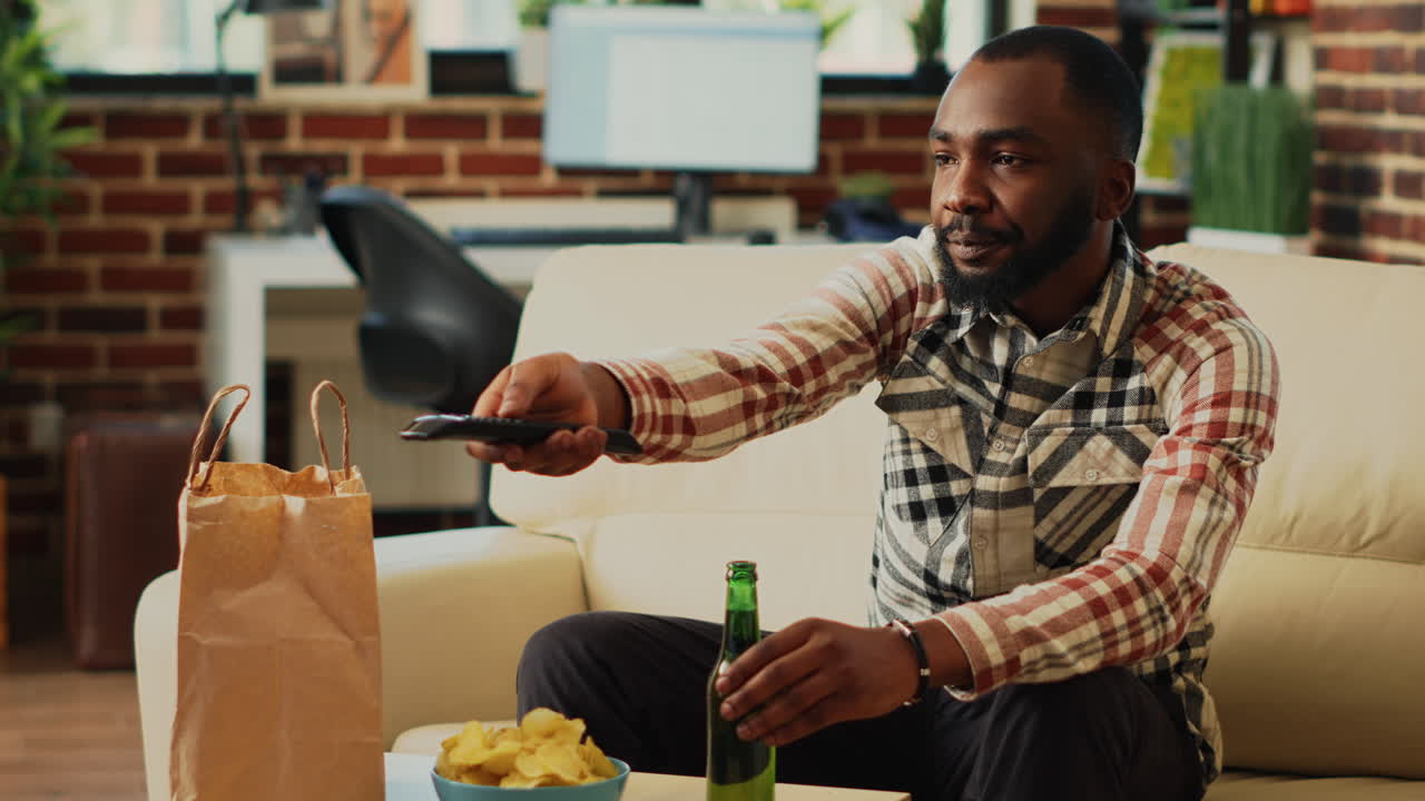 Relaxed guy having meal from fast food takeout place