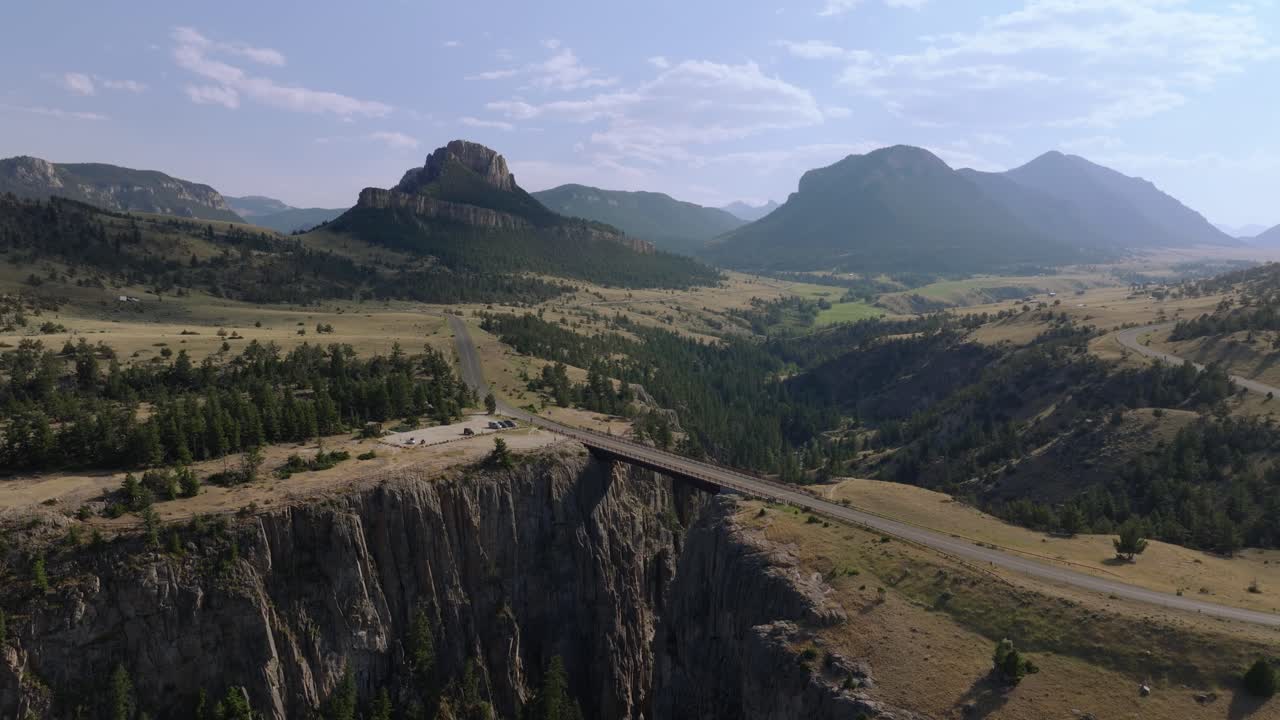 Scenic highway over bridge with mountain views, evokes adventure