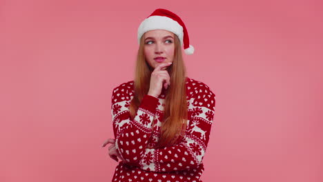 Excited-girl-in-Christmas-sweater-make-gesture-raises-finger-came-up-with-creative-plan-good-idea