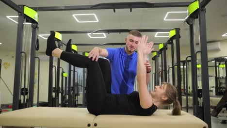 Personal Trainer Actively Helps Client Perform Abdominal Exercises Fitness Gym Personal Trainer Actively Helps Client Perform Abdominal Exercises Fitness Gym