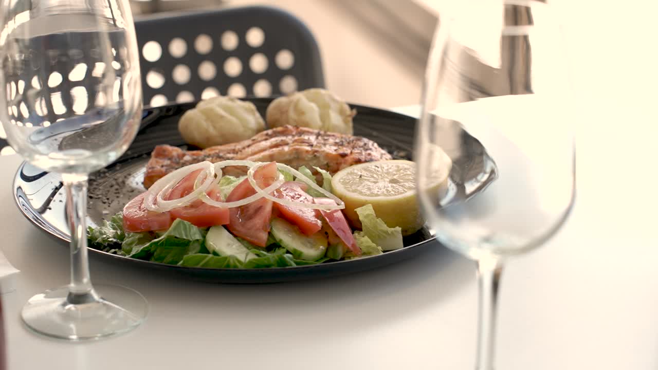 Savoring a vibrant salad and grilled salmon with lemon Close Up Shot