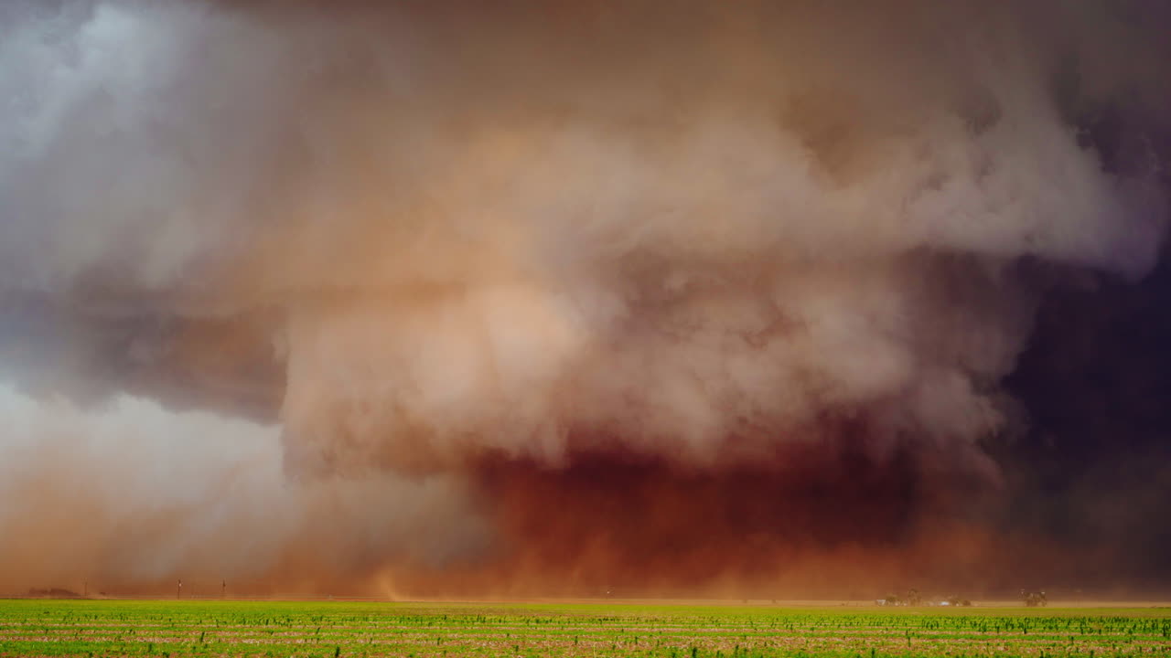 Tornado Funnel Kicking Up Dust and Debris in Open Farmland