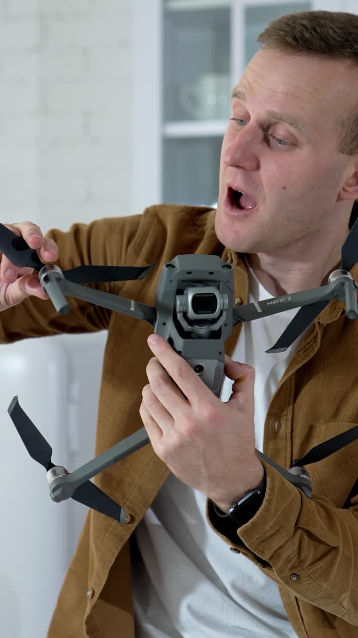 Kyiv, Ukraine, 2 May 2025: Man holding footage equipment. Young man holding drone for shooting video. Vertical video
