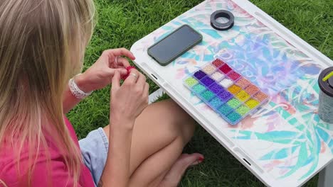 woman beading outdoors