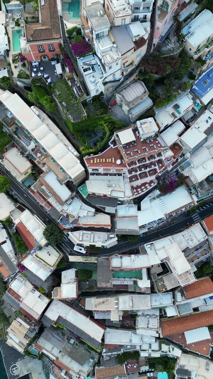 Positano hills houses Italy Italian riviera aerial drone top down traffic view narrow roads vertical