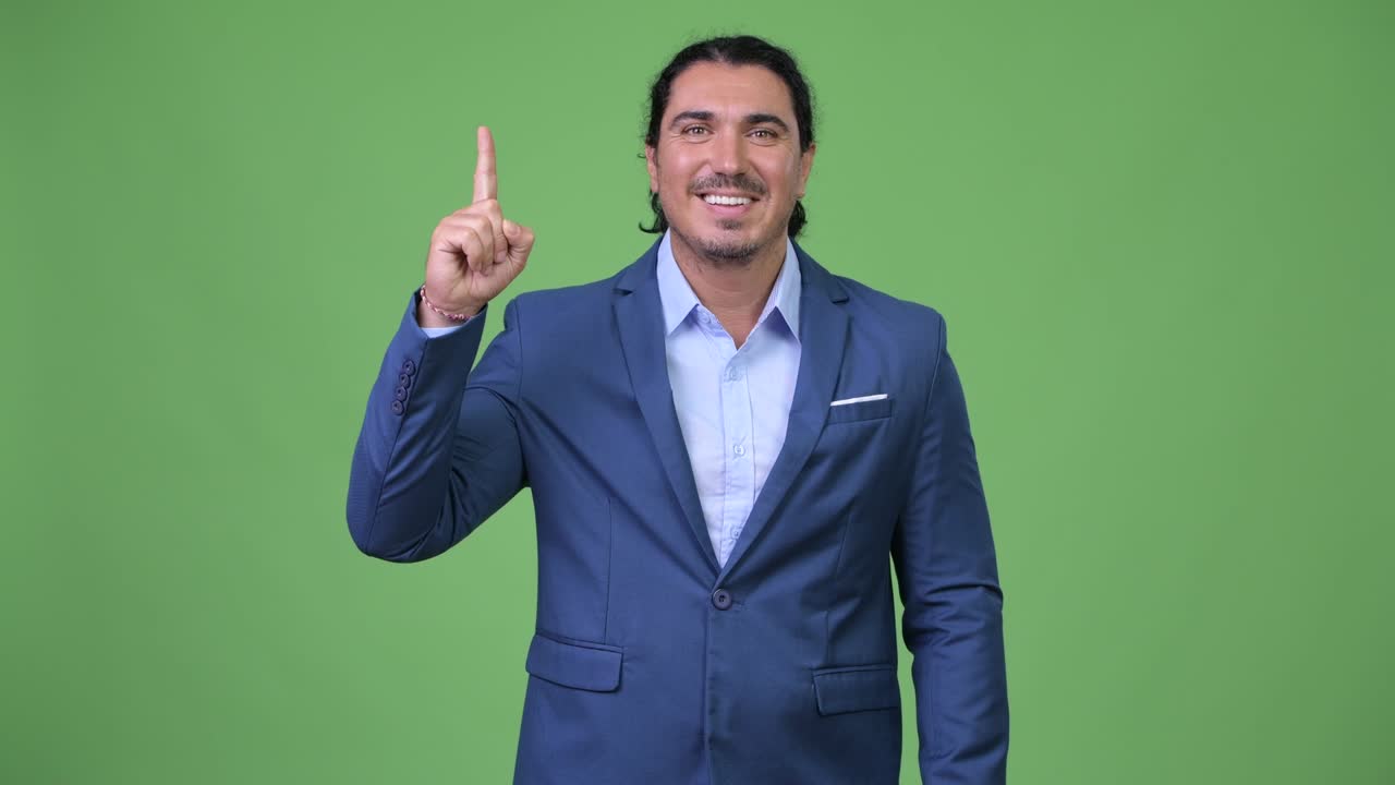 Handsome businessman pointing finger up